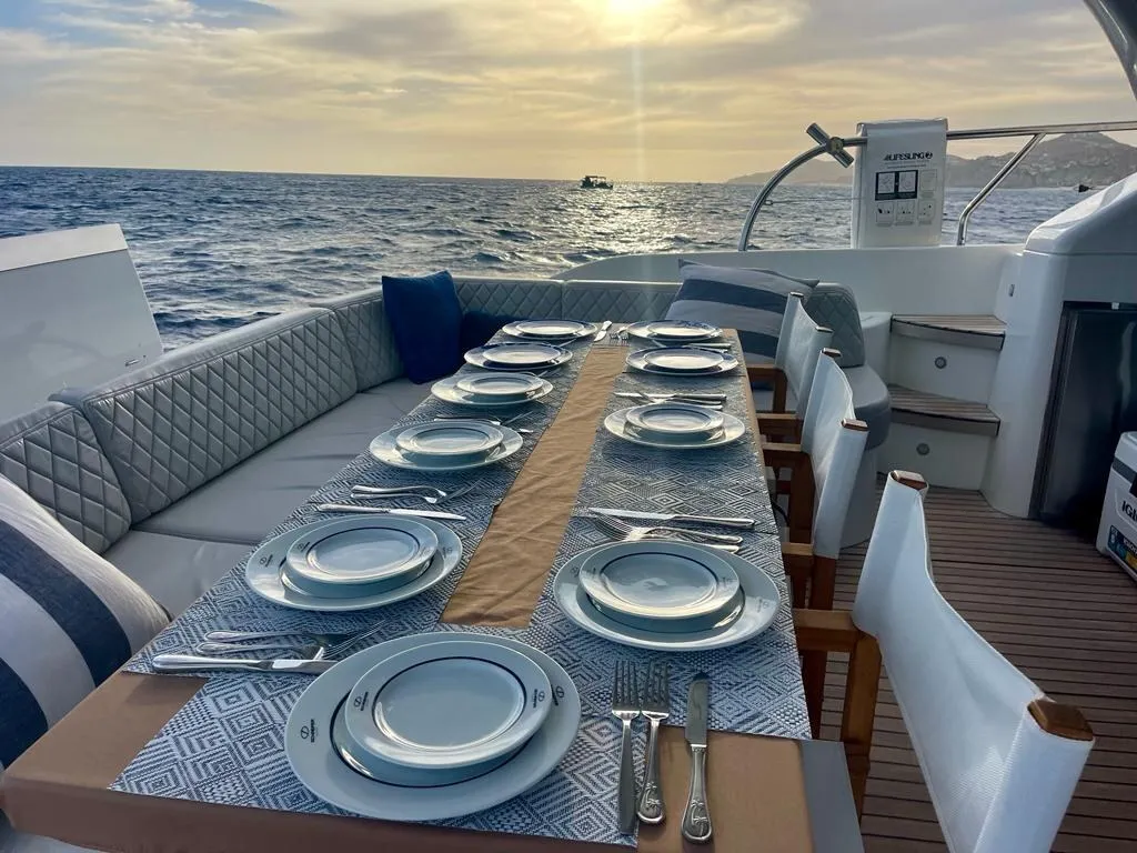 Sunset dinner table set on the flybridge of Bleed Blue